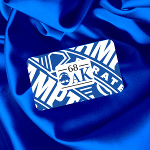 Square image of a 68 Oak Collective gift card displayed on a blue satin fabric background.