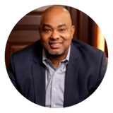 Headshot of Calvin Butts Jr. smiling and facing the camera.