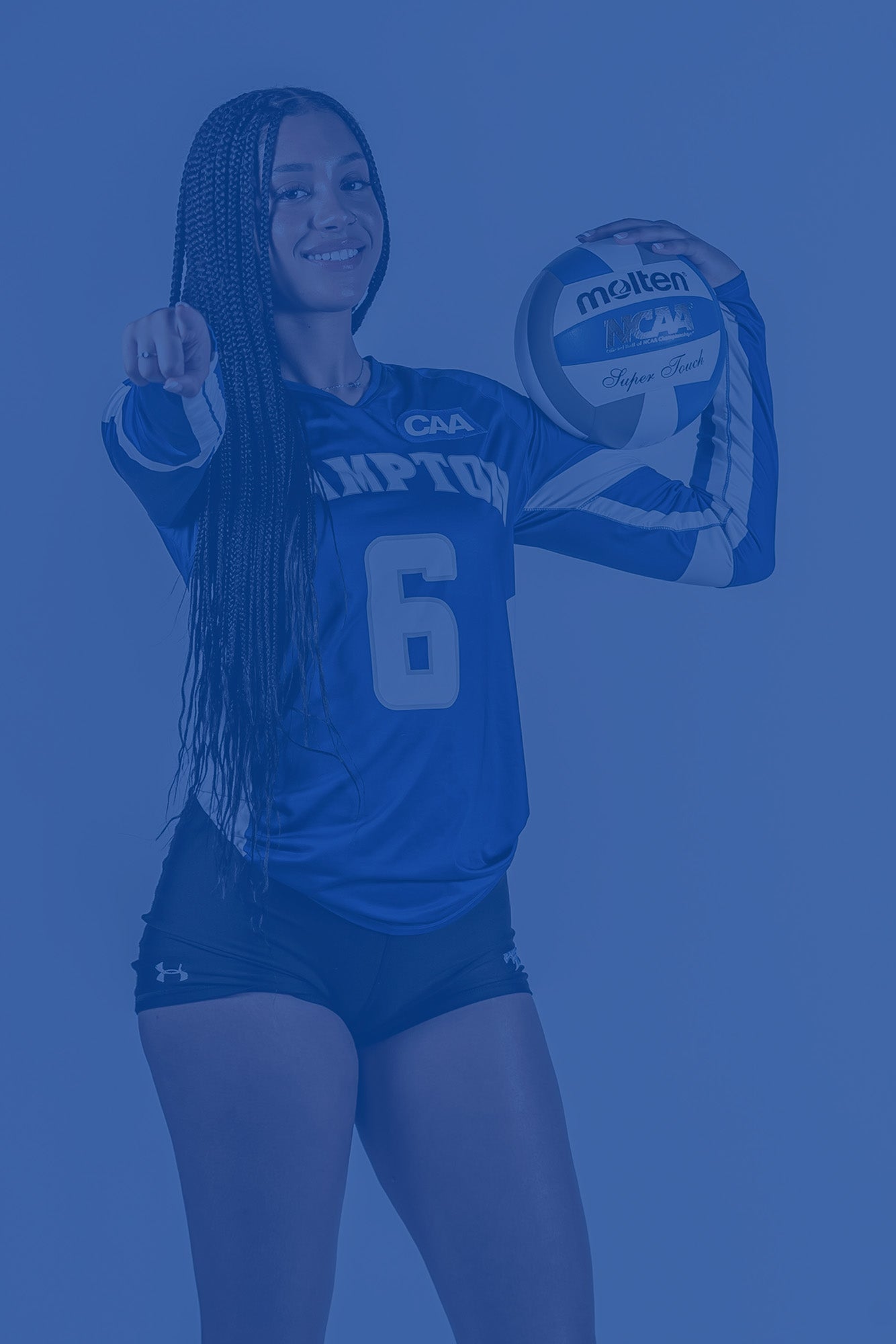 Hampton University volleyball player in blue uniform holding a volleyball and pointing toward the camera, with a blue color overlay on the image.